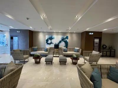 a waiting room with couches and chairs in a lobby at Coast Residences 40th Floor Penthouse Pasay Manila in Sampong