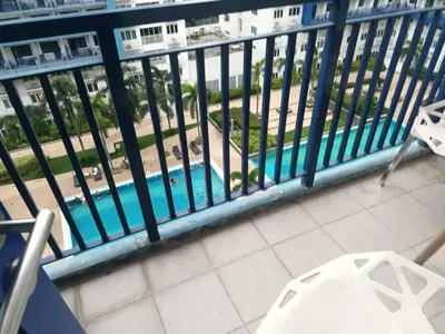 a balcony with a view of a swimming pool at Sea residence MOA KC PLACE in Manila