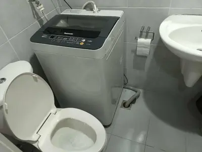 a small bathroom with a toilet and a sink at Sea residence MOA KC PLACE in Manila