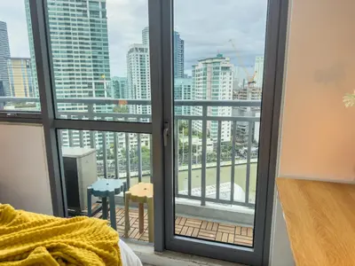 a room with a window with a view of a city at Unique and Quiet Studio Unit in Mandaluyong or Makati with Fast WiFi & Best City View in Manila