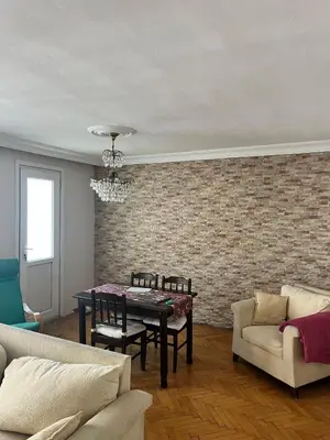 a living room with a table and a brick wall at Becca's double bedroom alongside Metrobank Makati in Manila