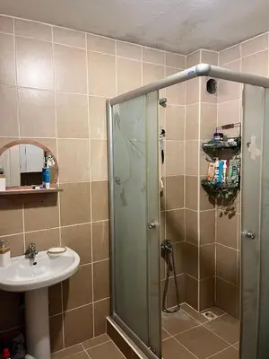 a bathroom with a shower and a sink at Becca's double bedroom alongside Metrobank Makati in Manila