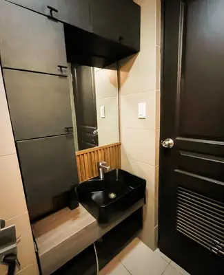 a bathroom with a black sink and a shower at Dibuho Studio in Manila