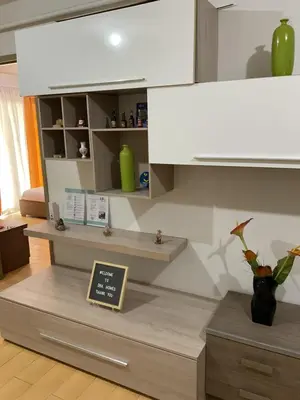 a kitchen with a counter with a shelf and a sign at DBK HOMES Sorrento Oasis in Manila