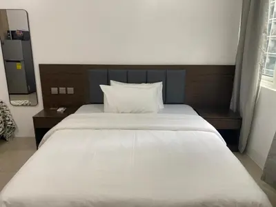 a large white bed in a room with a window at Near MOA - Cozy Staycation 22D in Manila