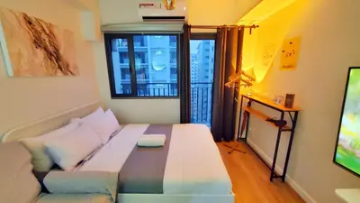 a living room with a couch and a television at Pikamon - 15 mins to Airport - Arcade - Shore 2 - MOA in Manila