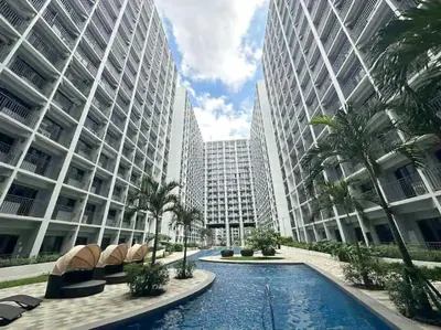 a swimming pool in front of two tall buildings at Pikamon - 15 mins to Airport - Arcade - Shore 2 - MOA in Manila