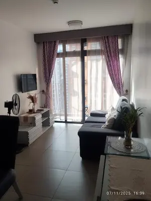 a living room with a couch and a large window at HAPpycation Portocondo in Manila