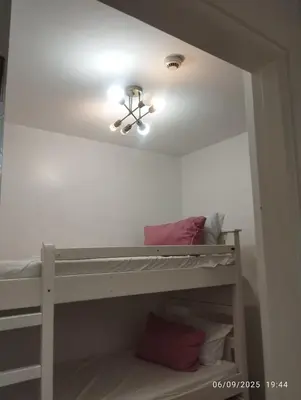 a bedroom with a bunk bed with a ceiling fan at HAPpycation Portocondo in Manila