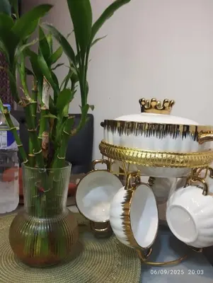 a table with a vase and a gold and white plate at HAPpycation Portocondo in Manila
