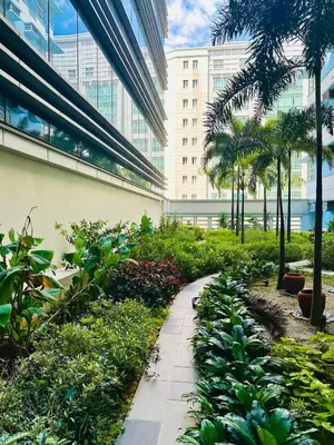 a garden in front of a building with plants at We Vibe, 101 Newport Blvd near the airport NAIA 3 in Manila