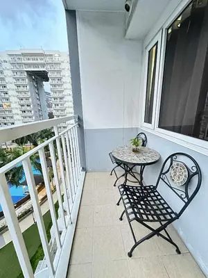 a small table and chair on a balcony at Shell residences Tower D in Manila