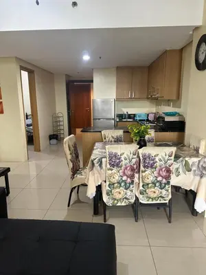 a kitchen with a table and chairs in a room at Shell Residences -weng's-place in Manila