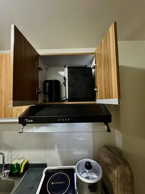 a kitchen with a stove and a microwave at Condotel Near NAIA T1, T2 and CAAP in Manila