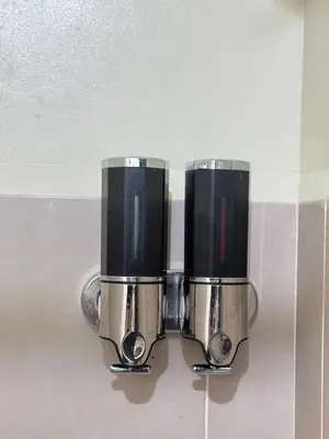 two silver and black toilets hanging on a wall at Condotel Near NAIA T1, T2 and CAAP in Manila