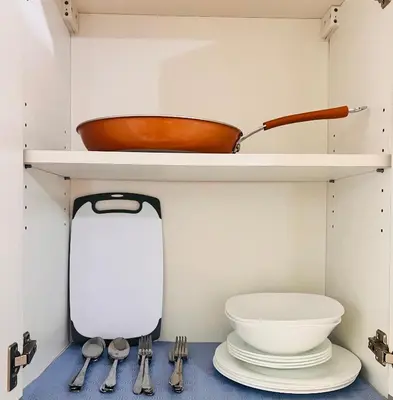 a kitchen with a shelf with a bowl and utensils at New 1BR in Mandaluyong 40SQM in Manila