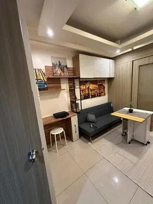 a living room with a couch and a table at Koro Den at Shore Residences in Manila