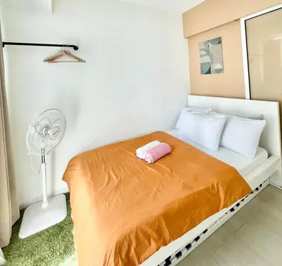 a small bedroom with a bed and a fan at Azure Urban Resort Residences Parañaque City in Manila