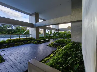 a courtyard of a building with plants at Condo- Park McKinleyWest Big1Br unit -Pool View in Manila
