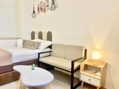 a small room with a bed and a chair and a table at Sky Condotel Staycation in Manila