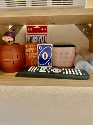 a shelf with a remote control and other items on it at Sky Condotel Staycation in Manila