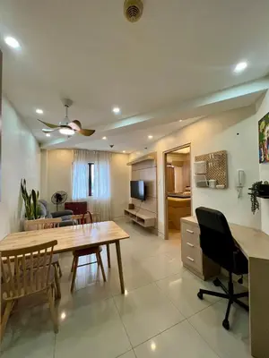 a living room with a table and a dining room at SRR NAIA T3 - Month of January - New Year PROMO Php 1,999 - 1 BR Interior Designed Unit in Manila