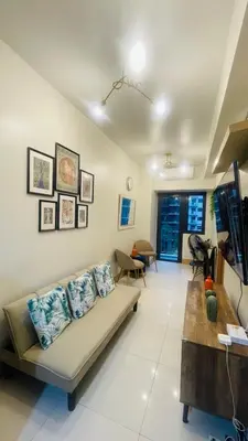 a living room with a couch and a table at Luna Suite in Manila