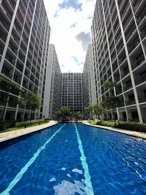 a large swimming pool in a city with tall buildings at Erin's Place in Manila
