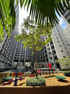 a playground in front of a building with a tree at Erin's Place in Manila