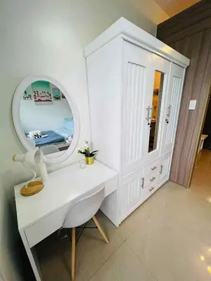 a bathroom with a white vanity and a mirror at Erin's Place in Manila