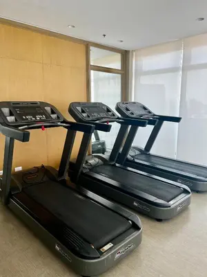 a row of three treadmills in a gym at Vista Shaw Residences in Manila