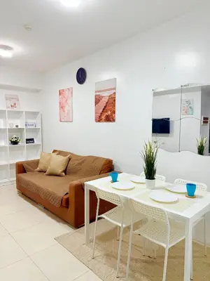 a living room with a couch and a table at Vista Shaw Residences in Manila