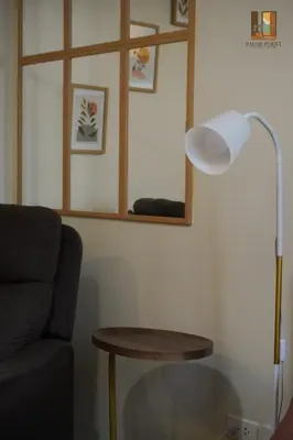 a living room with a lamp and a table at Pause Point - Standford 3 Suites in Silang