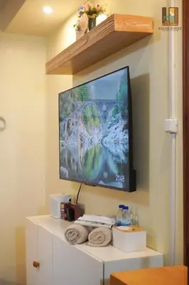 a flat screen tv hanging on a wall at Pause Point - Standford 3 Suites in Silang
