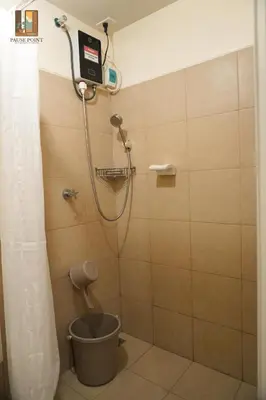 a shower with a bucket in a bathroom at Pause Point - Standford 3 Suites in Silang