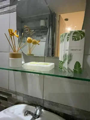 a bathroom counter with a sink and a mirror at Condo 2 bedroom victoria de makati in Manila