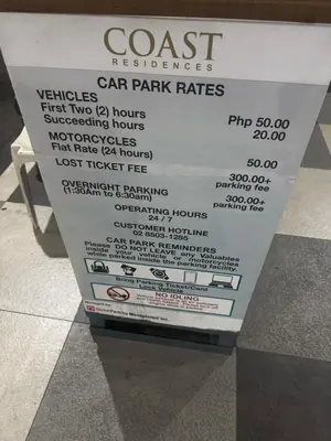 a sign for a car park rates in a store at Levi & Moon's Home in Manila