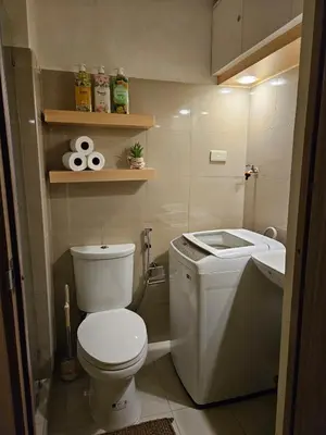 a small bathroom with a toilet and a sink at Cozy Escape Shore 2 Tower 3 -MOA - Pasay- 2 Beds in Manila