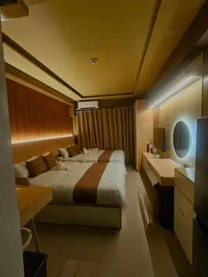a hotel room with two beds and a sink at Cozy Escape Shore 2 Tower 3 -MOA - Pasay- 2 Beds in Manila