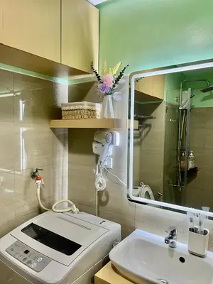 a bathroom with a sink and a washing machine at Condo Room Apartment in Mall of Asia Complex Pasay City - Near Airport in Manila