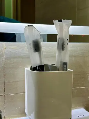 two toothbrushes in a white container on a counter at Condo Room Apartment in Mall of Asia Complex Pasay City - Near Airport in Manila