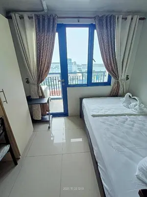 a bedroom with a bed and a large window at Sea Residences SM Mall of Asia Cj in Manila