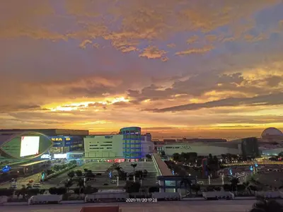 a view of a city at sunset with buildings at Sea Residences SM Mall of Asia Cj in Manila