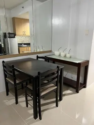 a kitchen with a table and two chairs and a table and a dining room at Sea Residences SM Mall of Asia Cj in Manila