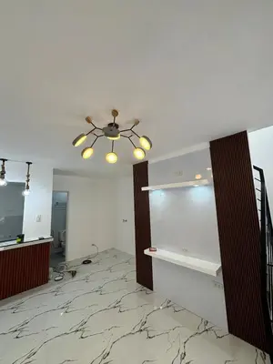 a living room with a ceiling fan and a hallway at A peace and quiet home away from your home in Calamba