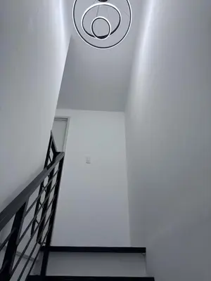 a hallway with a ceiling fan and a staircase at A peace and quiet home away from your home in Calamba
