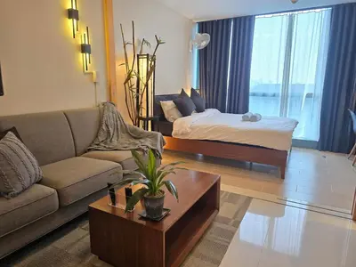 a living room with a couch and a bed at Very Cosy One Uptown near Grand Hyatt Hotel BGC Uptown Mall and St Lukes Medical Center in Manila