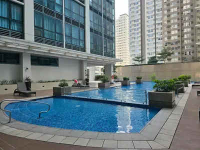 a large swimming pool in the middle of a building at Very Cosy One Uptown near Grand Hyatt Hotel BGC Uptown Mall and St Lukes Medical Center in Manila