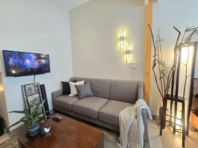 a living room with a couch and a coffee table at Very Cosy One Uptown near Grand Hyatt Hotel BGC Uptown Mall and St Lukes Medical Center in Manila