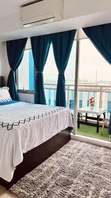 a bedroom with a bed and a large window at L A Azure staycation in Manila